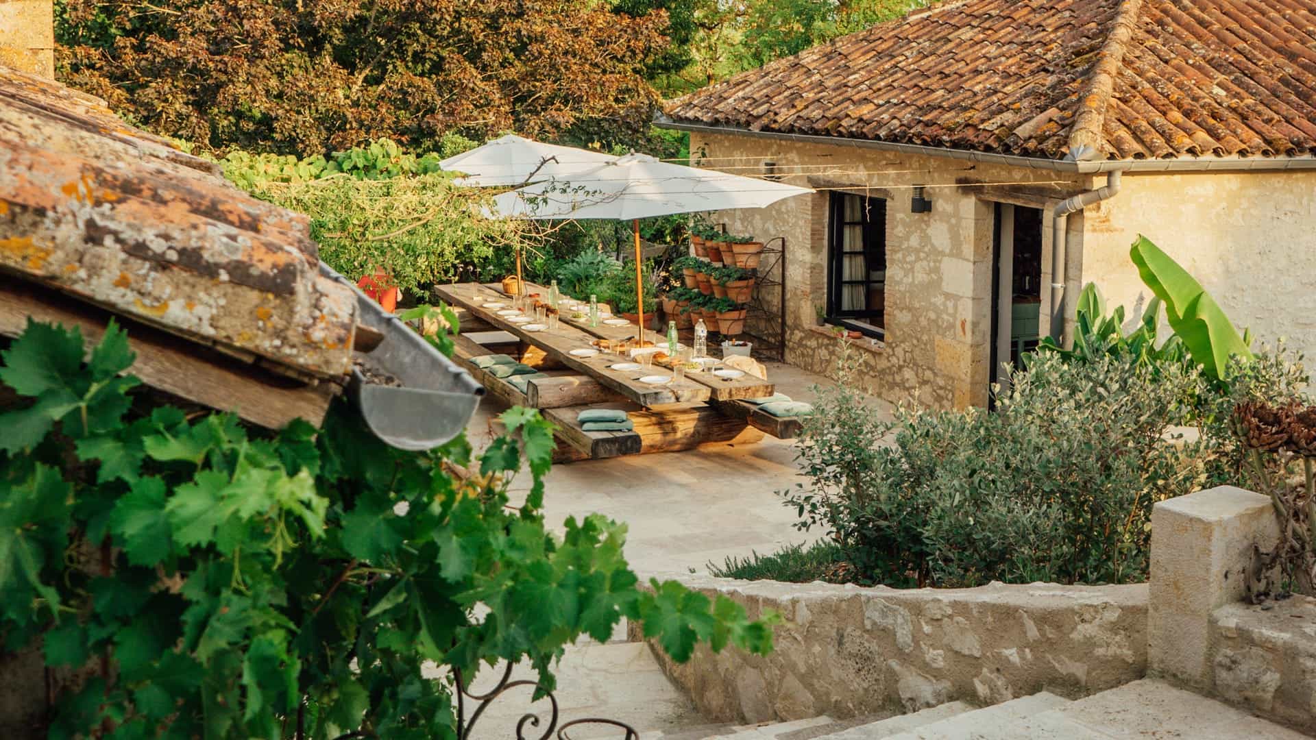 A set table on a terrace at dusk in the French countryside